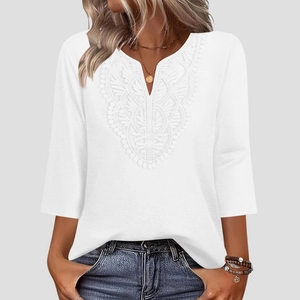 Close-up of elegant V-neckline with delicate lace embroidery on a white 3/4 sleeve blouse