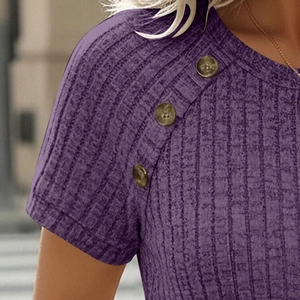 Detail view of purple ribbed knit top with decorative amber buttons on the shoulder seam