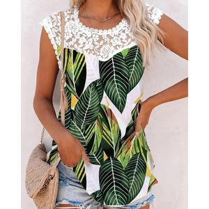 Detail of delicate white lace trim on a round neckline with tropical leaf print blouse
