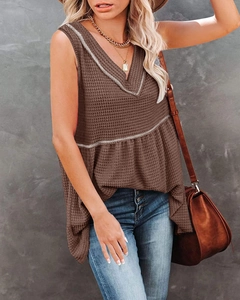 Detail of brown waffle knit v-neck tank top with ruffle hem and contrast trim