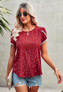 Detail of burgundy short sleeve top featuring heart print and delicate white lace trim