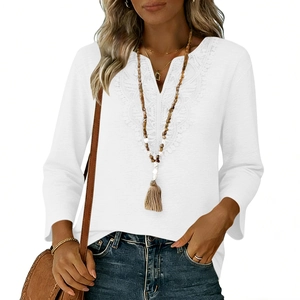 Close-up of V-neck white top featuring intricate lace stitching and breathable fabric
