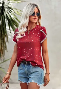 Close-up of white lace trim on sleeves of burgundy t-shirt with heart patterns