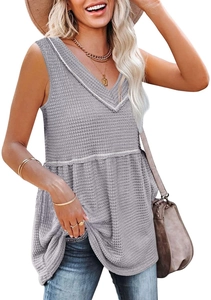 Close-up of gray waffle knit fabric texture on a sleeveless V-neck top with ruffled hem