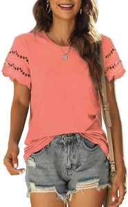 Detail of coral pink T-shirt featuring intricate lace embroidery and ruffled sleeves