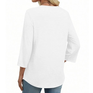 Detail view of the back of a white V-neck lace patchwork top with curved hemline