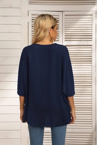 Back view of elegant navy blue batwing sleeve chiffon blouse on a model in soft lighting