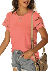 Detail of coral pink T-shirt featuring intricate eyelet lace trim on short sleeves
