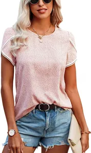 Detail of pink floral blouse featuring delicate white lace trim on ruffled short sleeves
