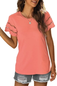 Close-up of intricate lace hollow-out crochet detail on the short sleeve of a coral T-shirt