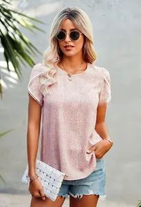 Detail of pink floral t-shirt featuring elegant lace trim sleeves and polka dot pattern