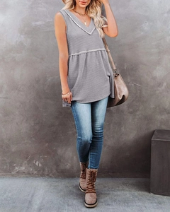 Detailed close-up of dark grey V-neck sleeveless top with waffle knit fabric texture