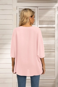 Rear view of a loose pink chiffon blouse with batwing sleeves and smooth drape fabric