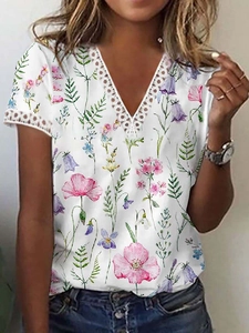 Close-up of V-neckline with delicate white lace trim and floral print on summer top