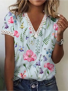 Close-up of white lace trim on the V-neck and sleeves of a floral summer t-shirt