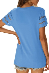 Close-up of sky blue T-shirt featuring intricate hollow embroidery lace on short sleeves