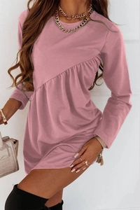 Detail of the asymmetrical ruffle seam and textured fabric on the dusty rose dress