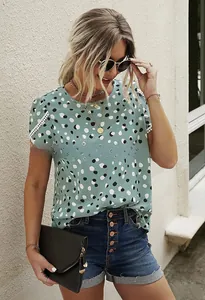 Detail of green polka dot t-shirt with white lace trim sleeves and casual round neck
