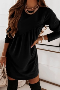 Detail of the high-waisted pleated gathering on a long-sleeve black round neck dress