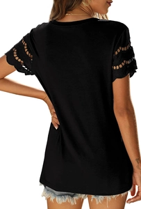 Close-up of black t-shirt back showing intricate eyelet lace detailing on the short sleeves
