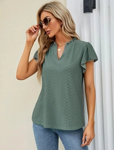 Detail of V-neckline and geometric hollow-out texture on sage green short sleeve top