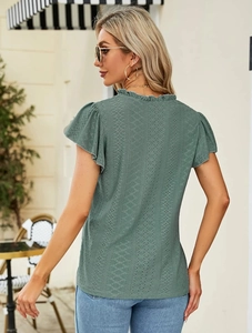 Detailed back view of light green jacquard top with geometric hollow patterns and ruffled sleeves