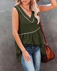 Detail of waffle-knit fabric and v-neck design on this olive babydoll tank top