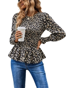 Close-up of smocked waist floral blouse with ruffled hem and long sleeves