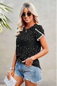 Detail of black heart print top with delicate white lace trim on the short sleeves