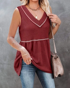 Detail view of deep red waffle textured fabric on a sleeveless V-neck casual top
