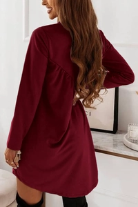 Detail view of the elegant pleated back design on a burgundy long sleeve tunic dress