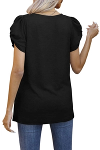 Detail view of the black puff sleeve short shirt back tailoring and fabric texture