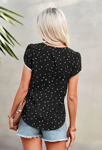 Close-up of black short sleeve top featuring white heart print and lace trim detailing