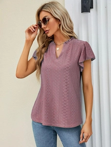 Close-up of V-neck eyelet embroidered short sleeve blouse with ruffled cuff detail