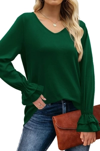 Detail of dark green V-neck top showing multilayered ruffle cuffs and knitted texture