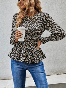 Detailed view of long-sleeved floral blouse featuring elegant smocked waist and peplum hem