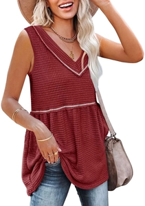 Detailed macro view of waffle knit fabric and ruffle hem on a red V-neck sleeveless top