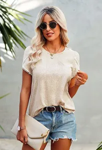 Detail of white lace patchwork on sleeves of beige polka dot short sleeve T-shirt