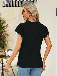 Close-up of black eyelet fabric texture and ruffle stand collar on a women's summer top