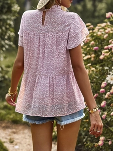 Detailed back view of a pink polka dot chiffon blouse with elegant ruffle trim and cutout