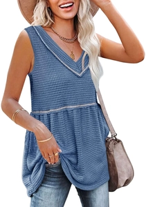 Detailed macro view of breathable waffle texture and V-neckline on blue sleeveless top