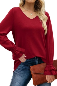 Close-up of elegant double-layered ruffle cuffs on a burgundy V-neck long-sleeve top