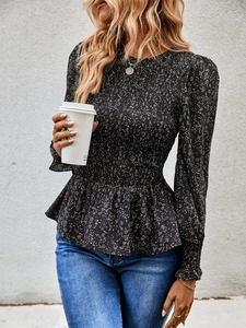 Detail of floral long sleeve peplum top featuring smocked waist and round neckline