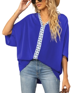 Close-up of V-neckline with geometric trim on royal blue chiffon batwing sleeve blouse
