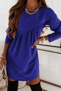 Close-up of royal blue long sleeve dress featuring asymmetrical pleated waist details