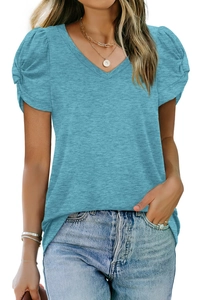 Detail of the elegant puff sleeves and pleat accents on the light blue V-neck T-shirt