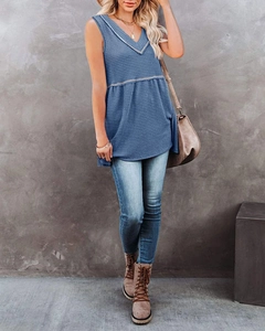 Detail view of indigo blue waffle knit tank top featuring contrast stitching and V-neckline