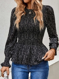 Detail of floral long sleeve top with smocked waist and ruffled hem texture
