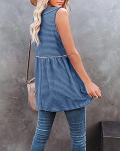 Detail view of the blue V-neck sleeveless top featuring waffle knit texture and babydoll cut