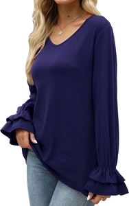 Detail of elegant ruffle cuffs and ribbed texture on the dark purple long sleeve shirt